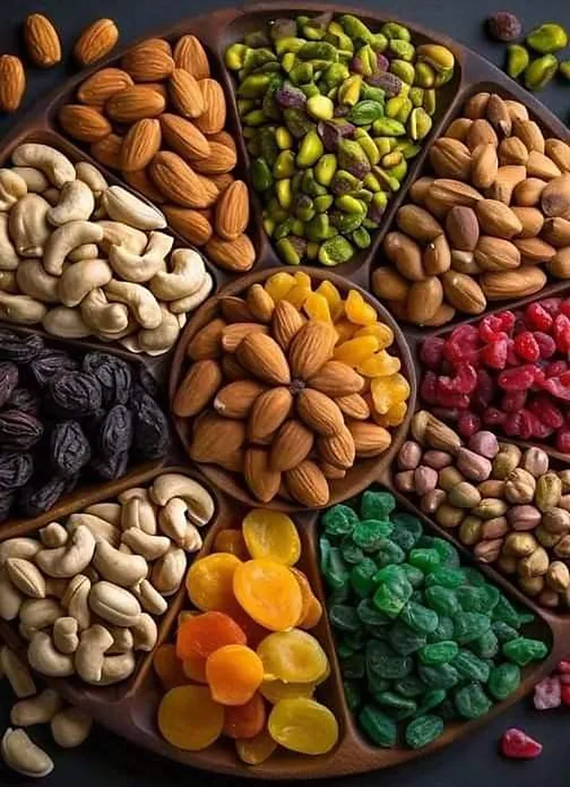 A tray of assorted nuts, dates and dried fruit